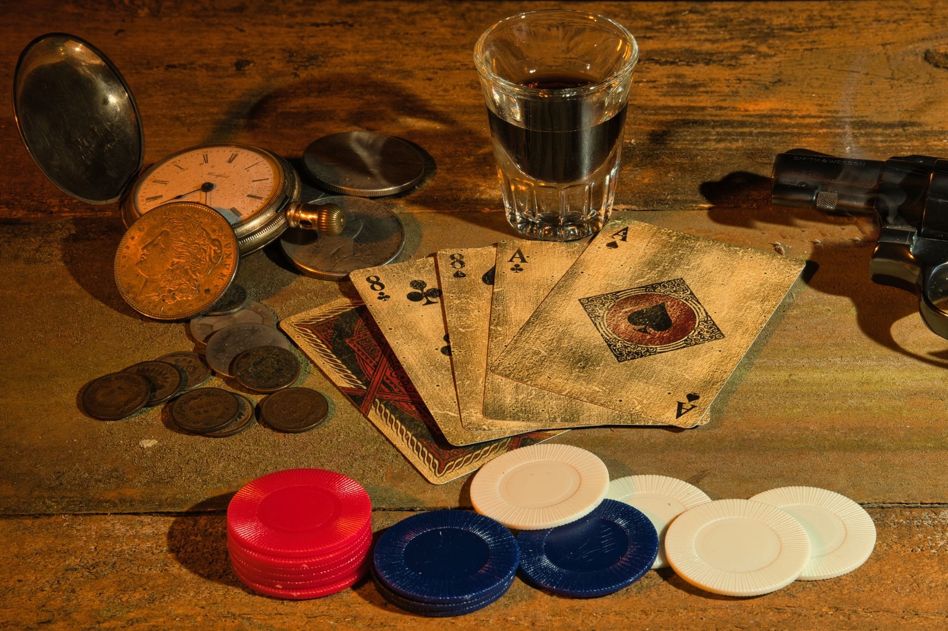 Poker chips, playing cards and coins in dramatic lighting — the Vaultara gaming atmosphere