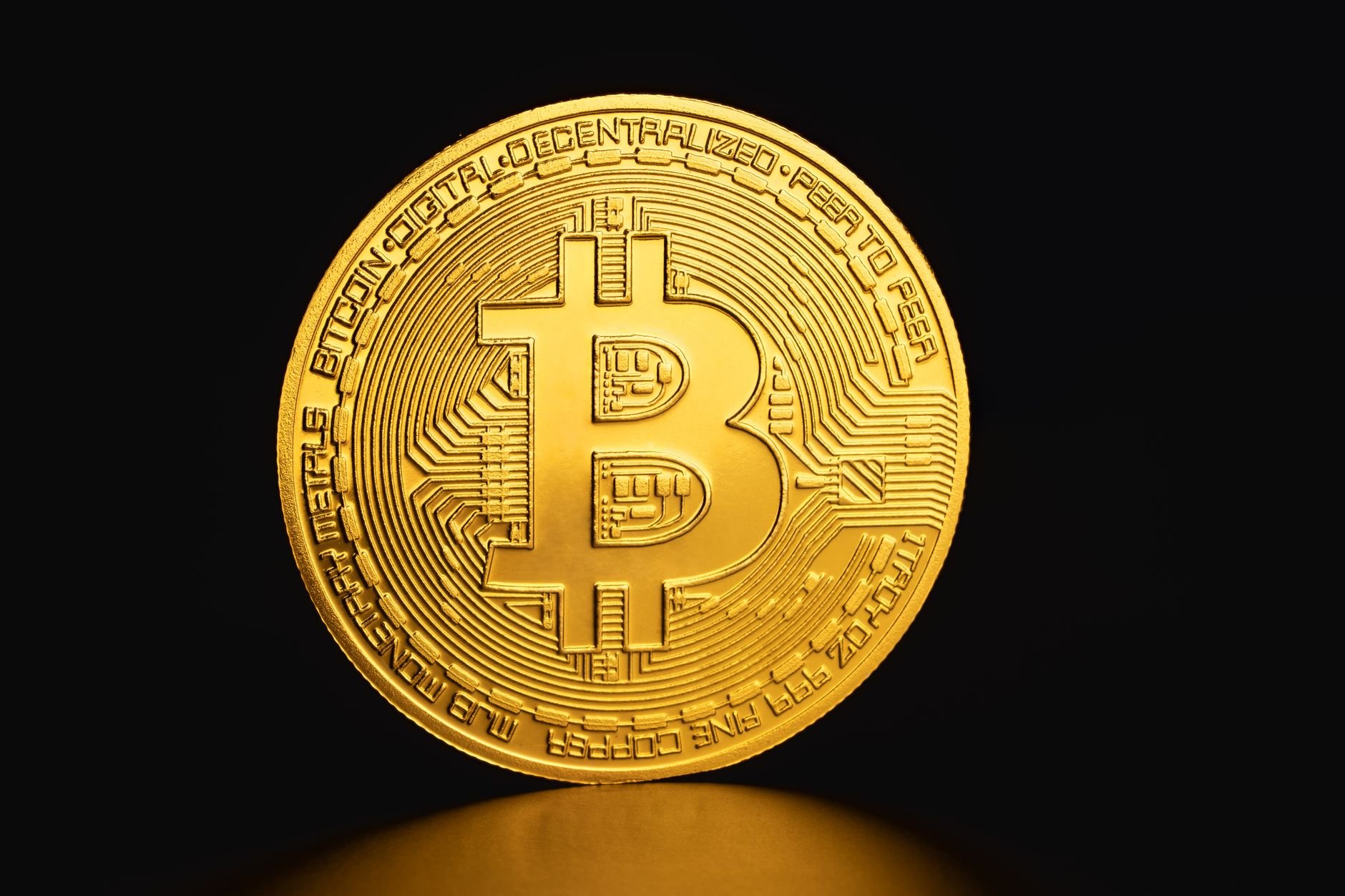 Golden Bitcoin coin on dark background — crypto withdrawals at Vaultara