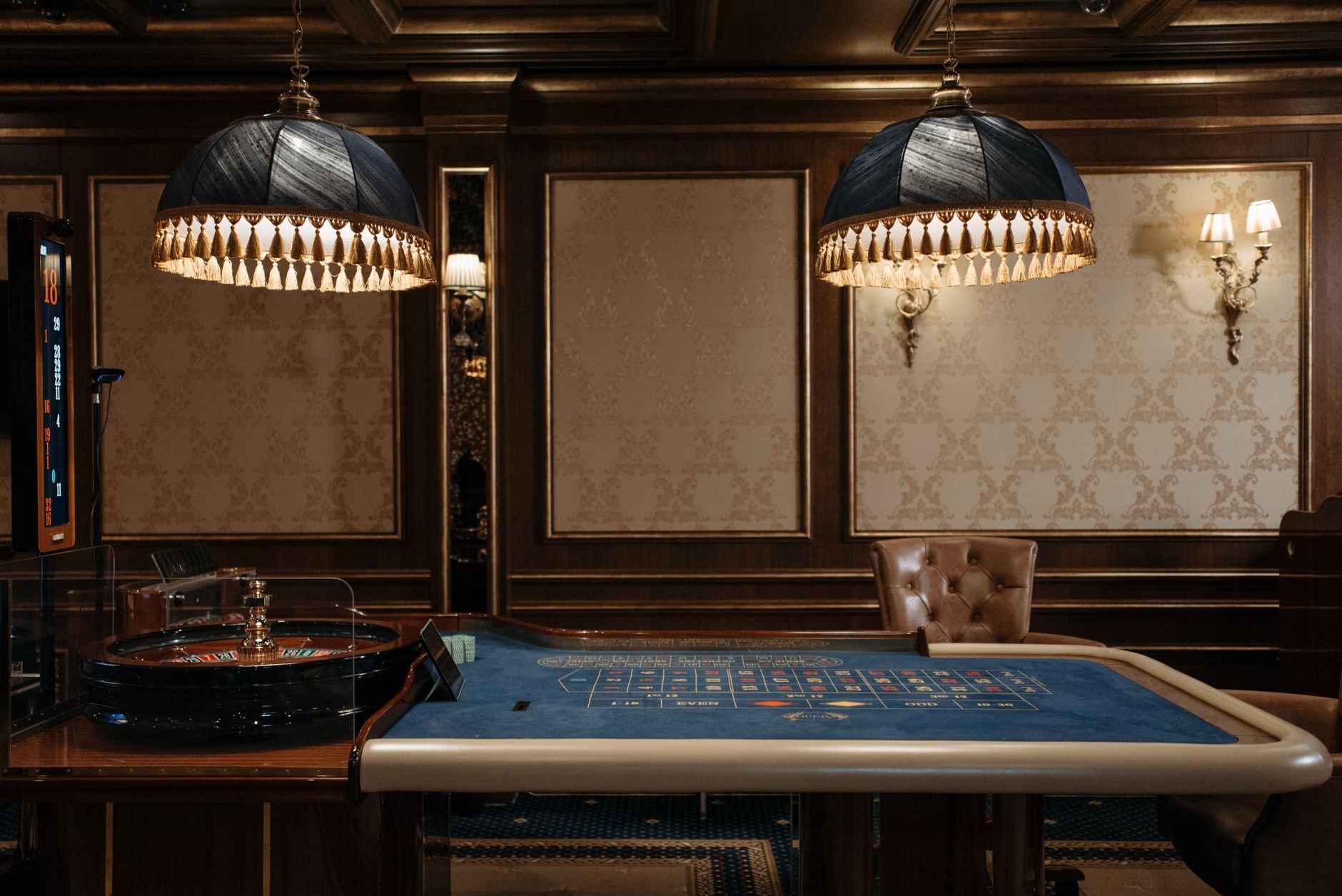 Luxurious casino roulette table with stylish lamps — Vaultara fair gaming
